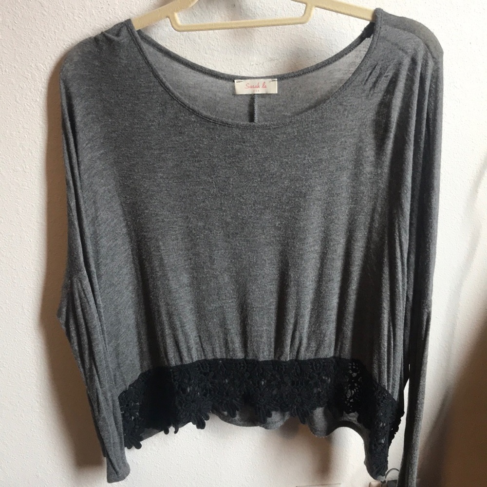 Long sleeved grey top with lace trim